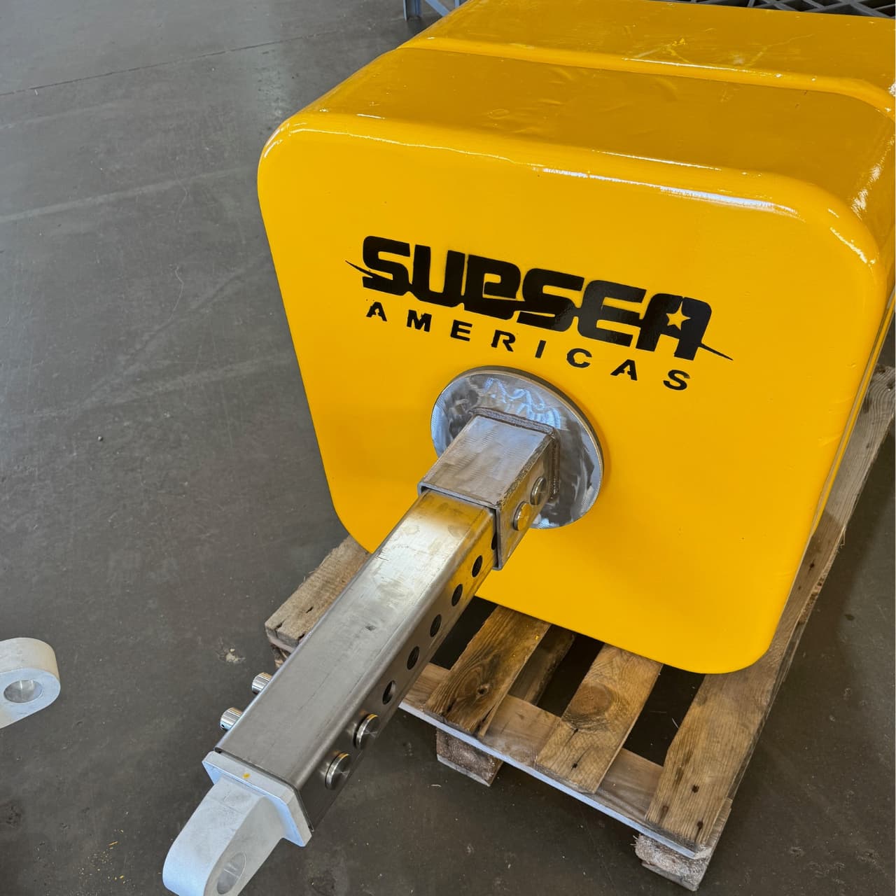 Three yellow Subsea Americas 250 lb modular buoyancy blocks on pallets
