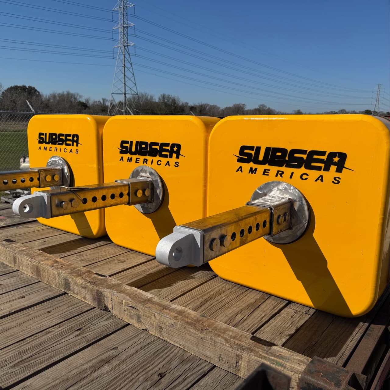 Close view of a yellow Subsea Americas modular buoyancy block with mounting hardware